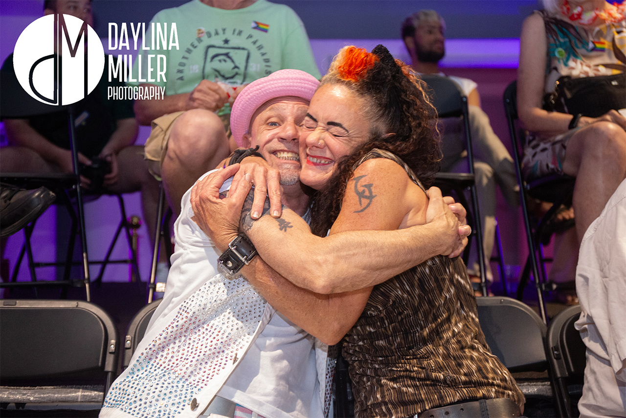 Andy and a friend sharing a heartfelt hug at the UNI-Tea Dance, showcasing the supportive community.