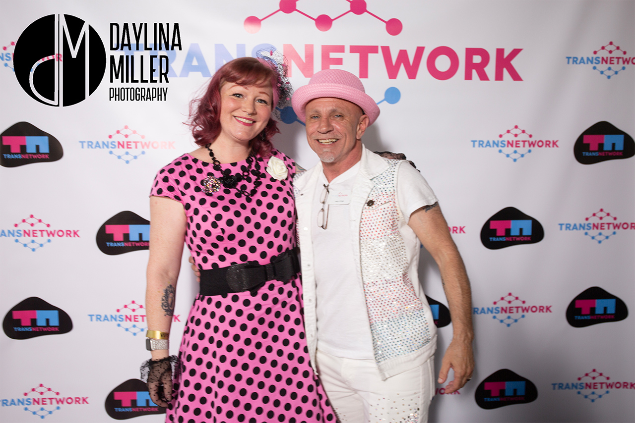 Andy, co-founder of TransNetwork, smiling and posing with a friend at the UNI-Tea Dance event.