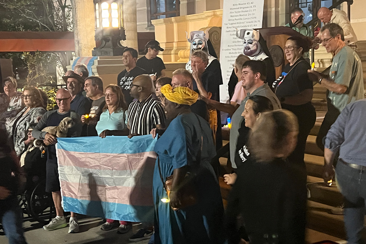 Attendees hold a transgender flag in honor of lives lost to violence during TDOR at St. Petersburg City Hall