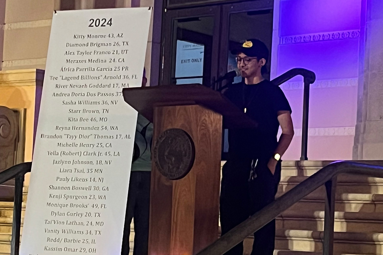 Zach, a young trans man, speaks at the podium during Transgender Day of Remembrance 2024 in St. Petersburg